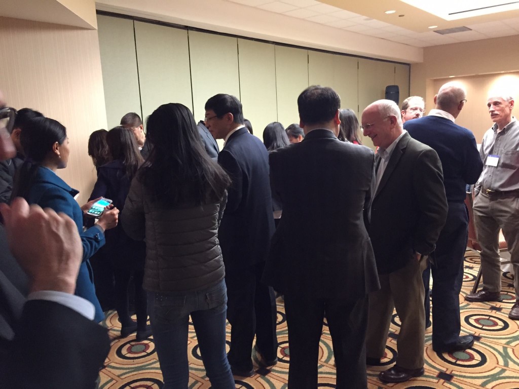 Reception attendees enjoy drinks and cake while perusing the journal. (Source: https://dukeupress.wordpress.com/2015/03/31/association-for-asian-studies-annual-meeting/)